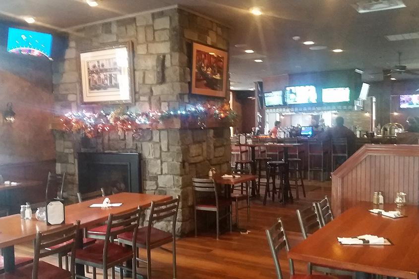 The interior at Bentley's Tavern, with plenty of wood paneling, is broken up into sections.
